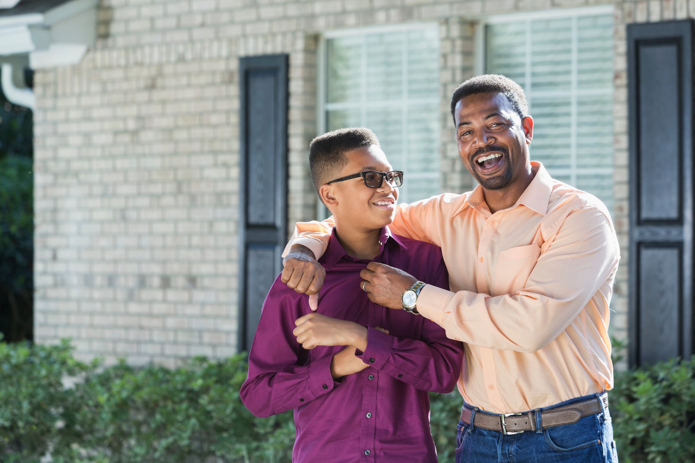 Black father and teenage son outdoors